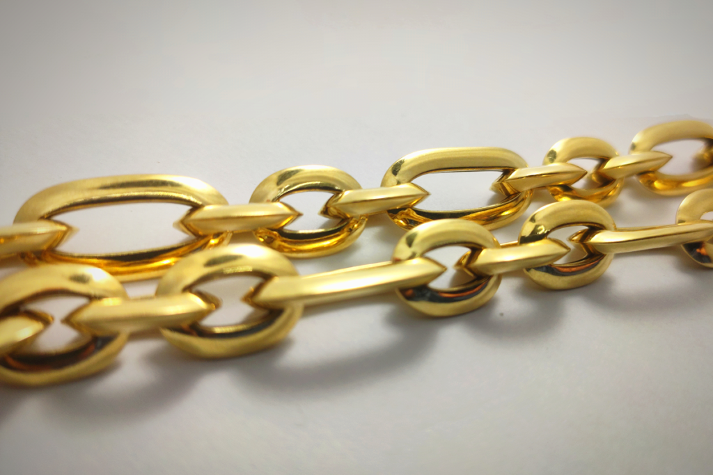 Close-up of gold chain links showing different chain construction