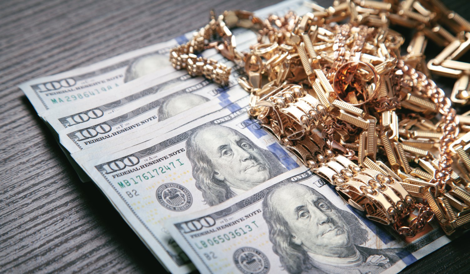Cash, gold and jewelry on a counter